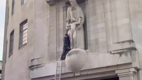 London - Someone climbed onto the BBC building & smashed up the Eric Gill pedo statue