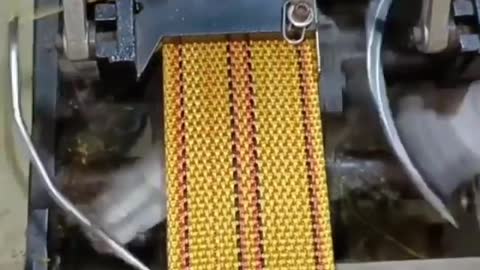 This is how it's done; Automated system, weaving some kind of a belt.