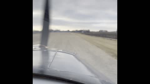 Airplane taking off from a unpaved runway
