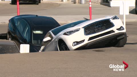 Sinkhole swallows several cars at Edmonton dealership