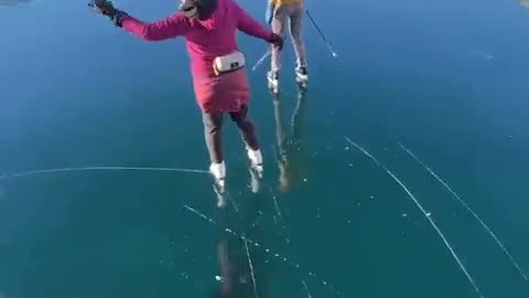 Skating over the clear glassy ice of rabbit lake in Canada