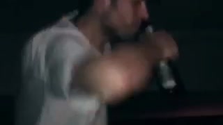 Guy in white shirt drinking on table and falling down