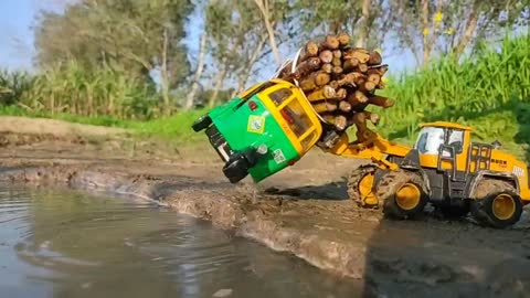 Auto Rickshaw And Mini Truck Pulling Out Crane