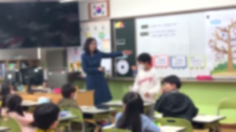 Blurred, students in elementary school classrooms with teachers