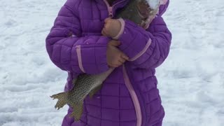 Daughter's First Fish Through the Ice