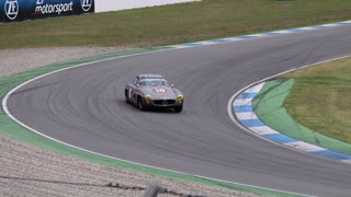 Vintage racecar driving along speedway