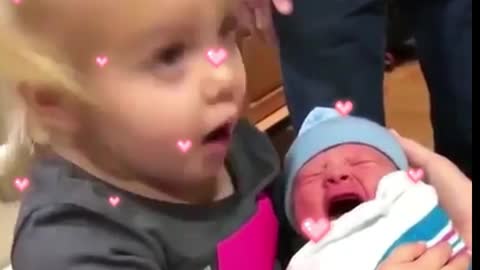 The sister hugged the newborn baby, kissed and cried, scared the sister