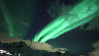 Aurora Borealis cascades sky in alien-green light