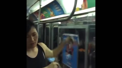 Look at the brave Asian woman tearing down LGBTQ propaganda ads in the subway!