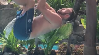 Guy slow motion rope swing fail into pool lands on back