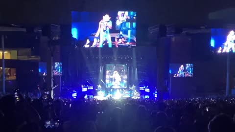 Jason Aldean puts an American flag over his shoulder while singing “Try That In A Small Town”