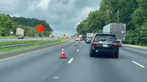 Driver Weaves in and Out of Cones in Traffic