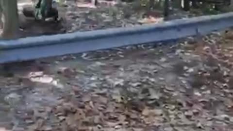 Guy in green flips over on bike over metal railing