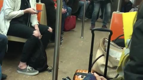 Man sings "lean on me" loudly on subway train