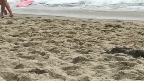 Two kids knocked down by wave on boogie boards