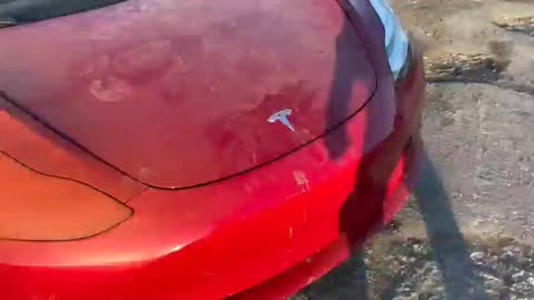 Destroyed Tesla in the city of Mariupol after the Russian attack