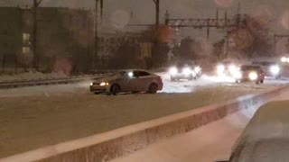 Car Does Donuts on Highway During Snowstorm