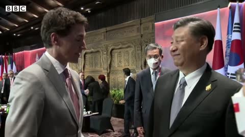 China and Canada leaders caught having tense exchange on camera - BBC News