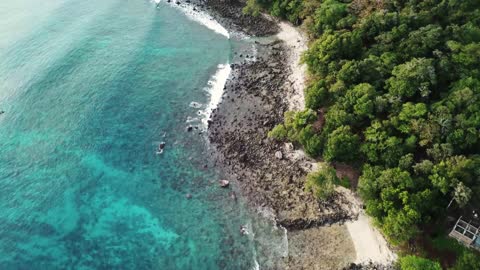 Droneview footage over a rocky Seaside