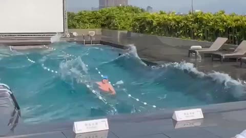 Taiwanese man swimming in his pool during the earthquake