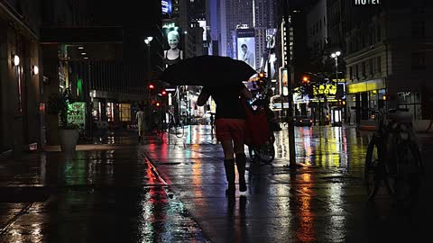 Alone In The Middle Of The City With The Streets Covered In Heavy Rain.