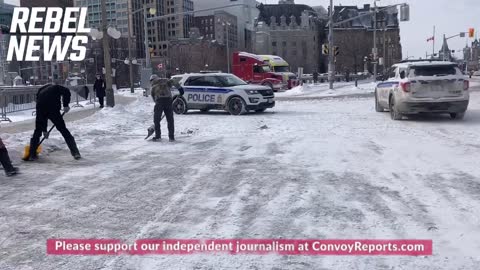 Police Supervise the Snow Clearing of the Streets