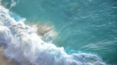 Turquoise Wave Crashing On A Beach