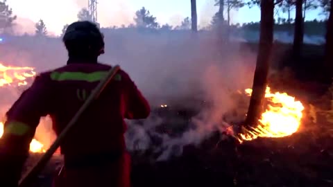 Firefighters battle to control wildfire in western Spain