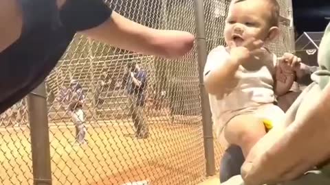 Girl with no arm gives a kid a high five