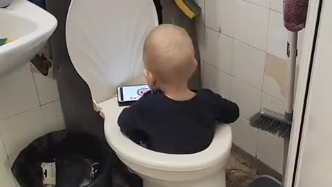 Kid Sits in Toilet While Watching Cartoons