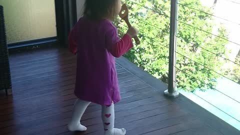 Precious toddler pretends to blow bubbles