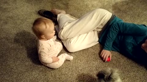 Baby adorably learns to share toys