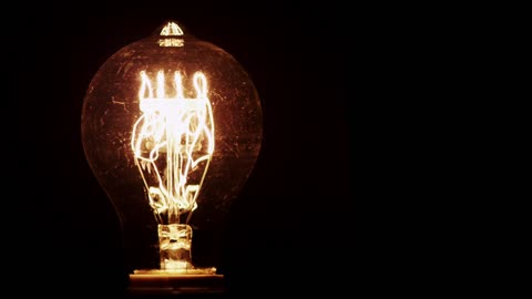 Light bulb illuminating in the dark