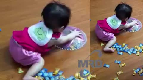 Baby playing with candy