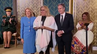 Jill Biden presents an "International Women Of Courage Award" to a biological male