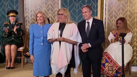 Jill Biden presents an "International Women Of Courage Award" to a biological male