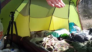 Lining up the shot before filming a vlog in a tent.