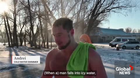 Siberian enthusiasts plunge into ice-cold river to kick off winter swimming season