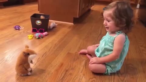 Little Girl Has A Tearful Reaction To A Repeating Toy Hamster...