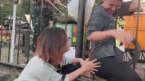 funny crazy video of a woman entering the garden through an iron fence viral