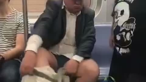 Guy putting on khaki pants on subway blue hat
