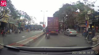 Scooter Tries to Squeeze Past Truck