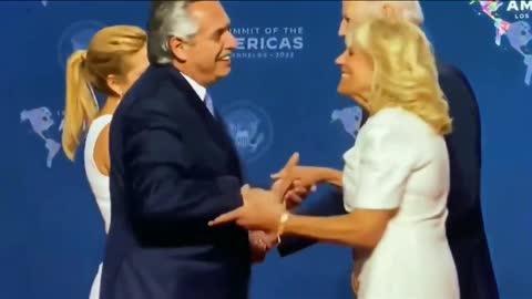 Joe Biden grab the President of Argentina's wife's hand and not let go