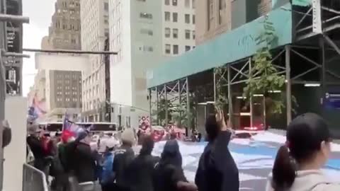 Trump supporters unveil a giant Thin Blue Line flag in front of Trump Tower