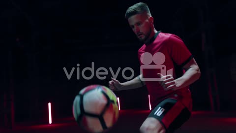 Soccer Player Kicking Up Ball