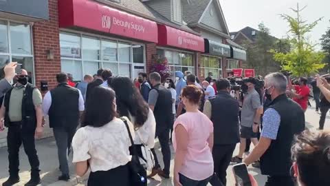 Protestors shout at Trudeau following a campaign stop.