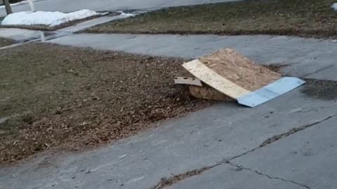 Kid does a backflip off small wooden ramp on his red bike, lands on front wheel and face plants into the grass