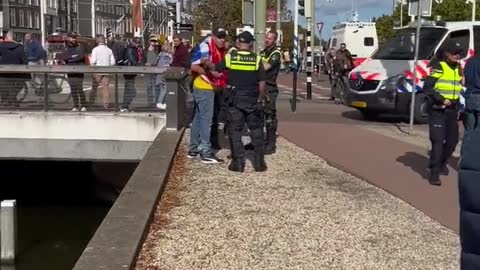 Hague, Netherlands: Police arrest protester, tow tractor (Sept. 20, 2022)