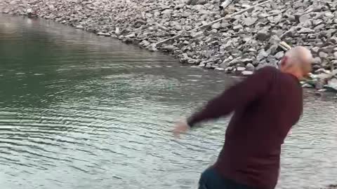 Dad skips rocks at the lake