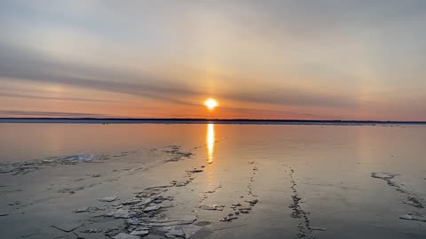 This is a sunrise over Lake Michigan while the March ice is melting and cracking.